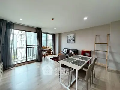 Spacious modern living room with dining area and large windows in a stylish apartment.