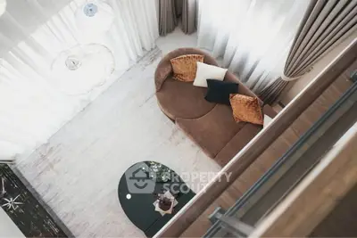 Elegant living room with modern sofa and stylish decor from a top view