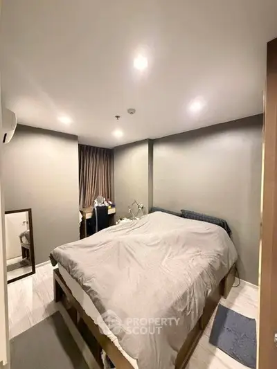 Cozy bedroom with modern decor and soft lighting, perfect for relaxation.