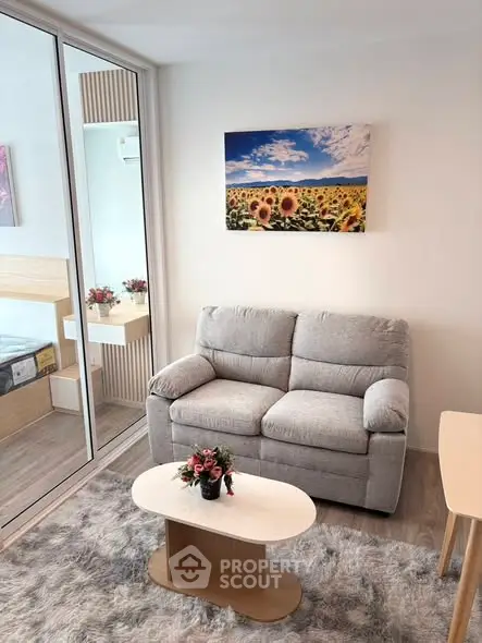 Cozy living room with plush sofa and modern decor in a bright apartment.