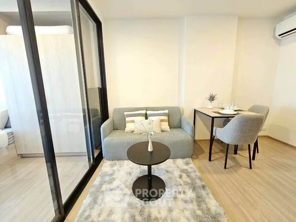 Modern living room with cozy sofa and dining area in open layout apartment