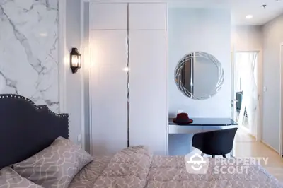 Elegant bedroom with marble walls, chic furnishings, and modern lighting, perfect for upscale urban living.