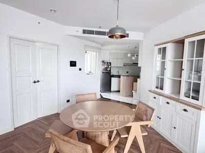 Modern dining area with wooden furniture and open kitchen layout