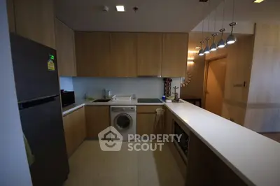 Modern kitchen with sleek appliances and stylish lighting