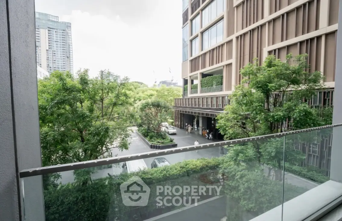Modern building exterior with lush greenery and glass balcony view