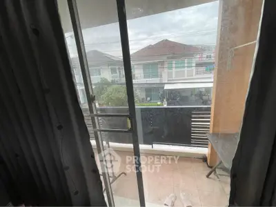 Charming balcony view from a cozy apartment with sliding glass doors and outdoor space.