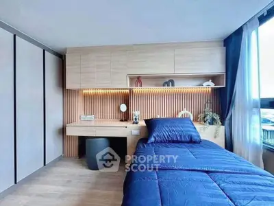 Modern bedroom with sleek wooden accents and stylish blue bedding