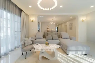 Luxurious living room with elegant decor and modern furniture, featuring a spacious layout and stylish lighting.