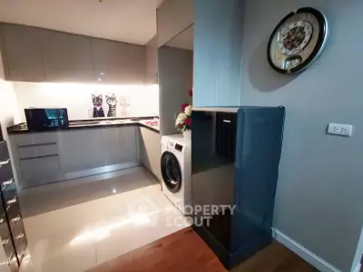 Modern kitchen with sleek cabinets and built-in appliances in a stylish apartment.