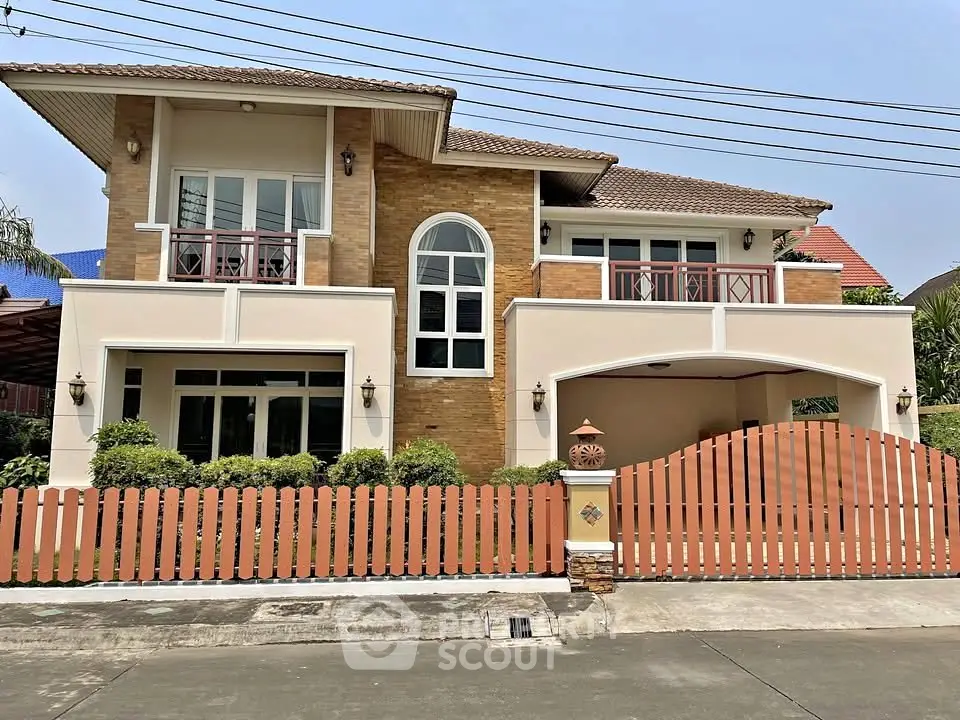 Stunning two-story house with modern architecture, large windows, and a charming fenced yard in a serene neighborhood.