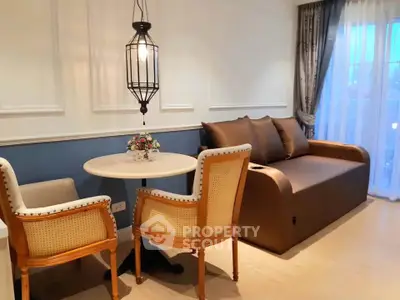 Charming living room with elegant seating and ambient lighting, perfect for relaxation and entertaining.