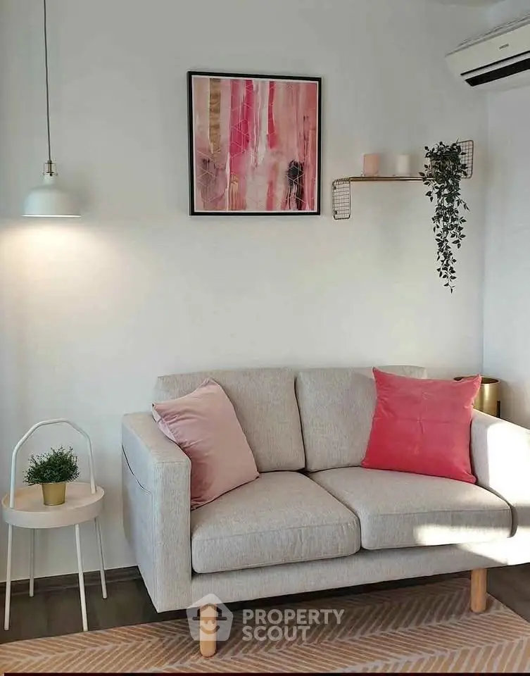 Charming living room with cozy sofa, stylish decor, and natural light, perfect for relaxation.