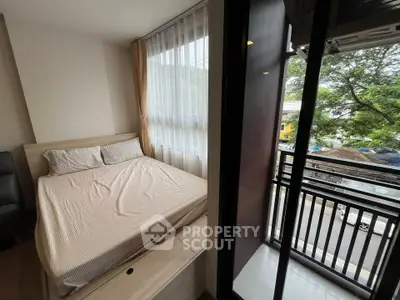 Cozy bedroom with balcony access and natural light in modern apartment