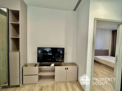 Modern living room with sleek TV stand and wooden flooring