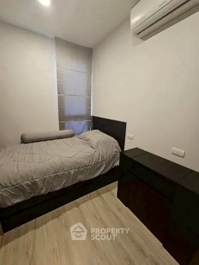 Cozy bedroom with modern air conditioning and minimalist decor