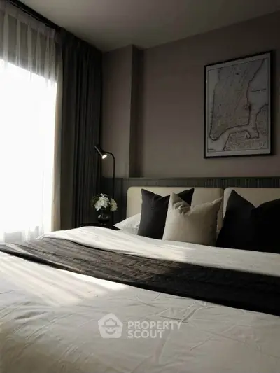 Elegant bedroom with stylish decor and natural light, featuring a cozy bed and modern design elements.