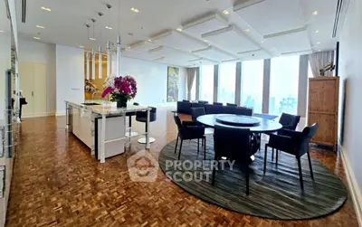 Luxurious open-plan living and dining area with stunning city views and modern decor.