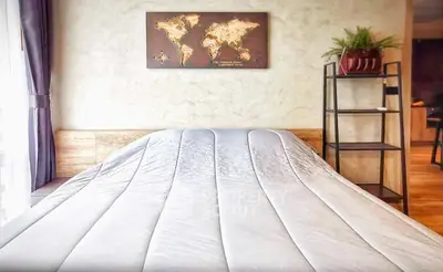 Cozy bedroom with modern decor and world map art on wall