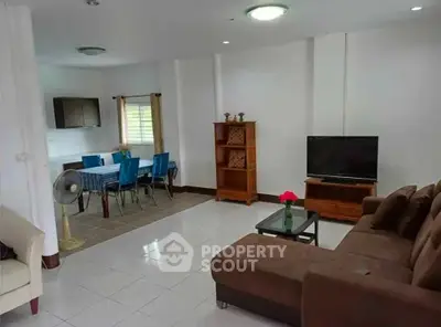 Spacious living room with modern furniture and dining area in open layout