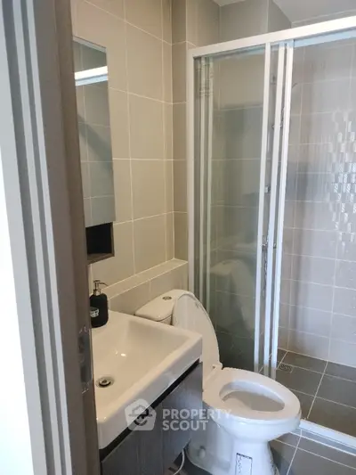 Modern bathroom with sleek design featuring glass shower and contemporary fixtures.