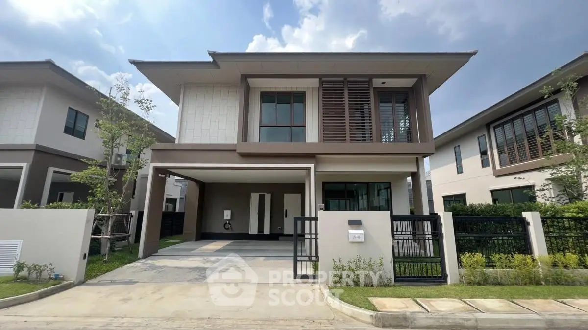 Modern two-story house with sleek design and spacious driveway in a serene neighborhood.