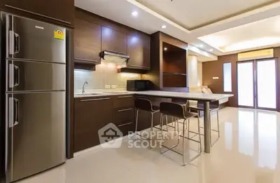 Modern kitchen with sleek design and open layout in luxurious apartment.