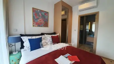 Cozy bedroom with stylish decor and ensuite bathroom, perfect for relaxation and comfort.