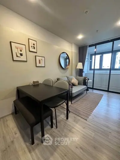 Modern living room with stylish decor and large windows in a contemporary apartment.