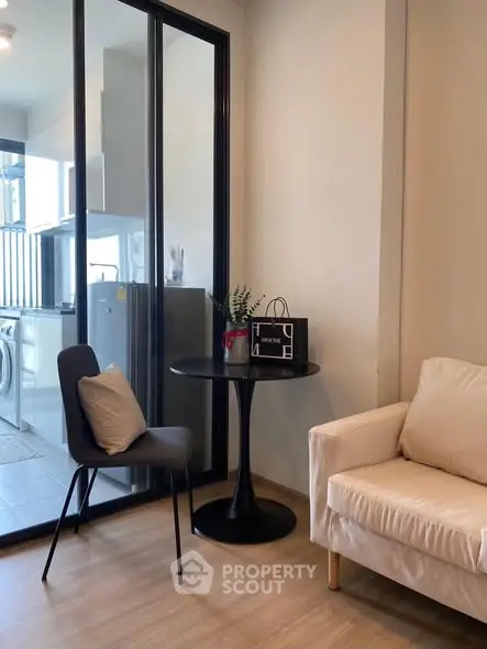 Modern living area with glass partition and cozy seating