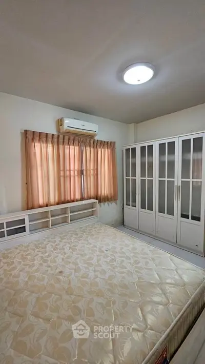 Spacious bedroom with large wardrobe and natural light