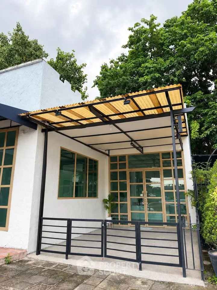 Charming modern exterior with covered patio and lush greenery, perfect for relaxation and outdoor enjoyment.