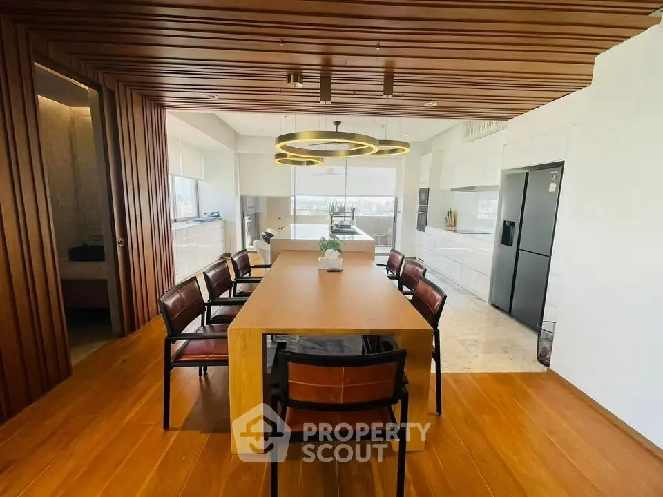 Luxurious dining area with modern wooden accents and open kitchen layout