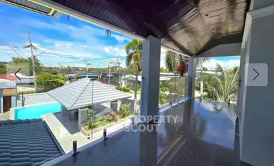 Spacious balcony with stunning view of pool and garden in modern home