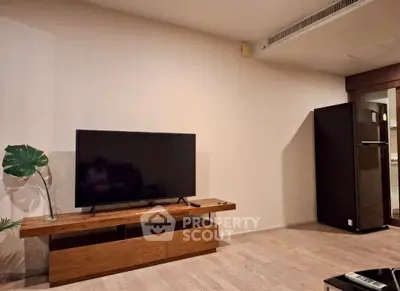 Modern living room with sleek TV setup and stylish wooden furniture, perfect for contemporary living.