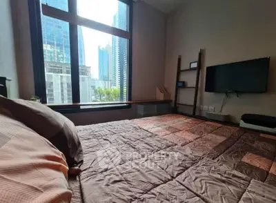 Modern bedroom with city view, featuring a cozy bed and wall-mounted TV, ideal for urban living.