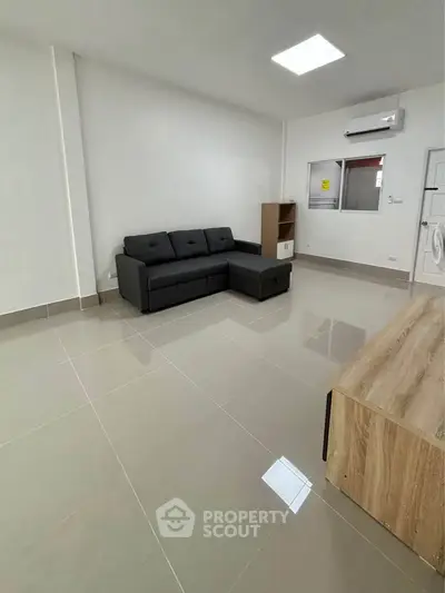 Modern living room with sleek black sofa and minimalist decor