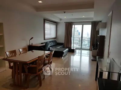 Spacious living room with modern furniture and city view balcony.