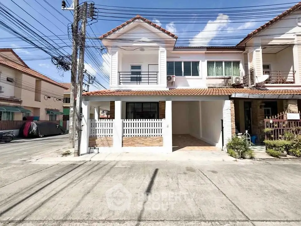 Charming townhouse with tiled roof and spacious driveway in a quiet neighborhood.