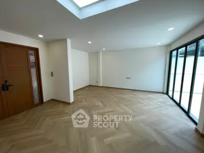 Spacious modern living room with wooden flooring and large windows