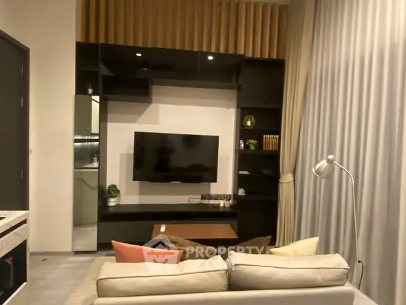 Modern living room with sleek TV unit and cozy sofa, perfect for relaxation.