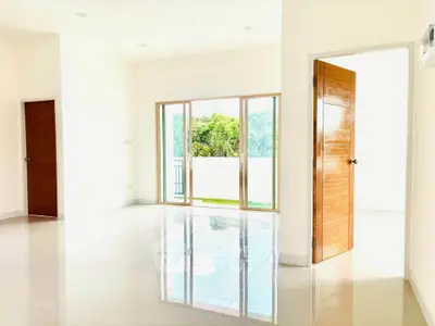 Bright and spacious interior with large windows and glossy tiled floors.