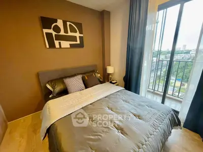 Modern bedroom with stylish decor and large window offering city views
