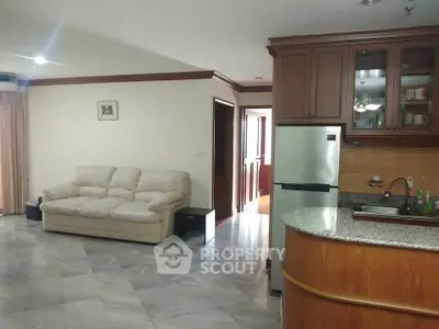 Spacious living room with modern kitchen and cozy sofa in open layout