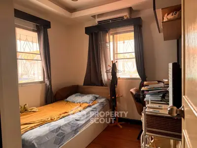Cozy bedroom with natural light and organized workspace