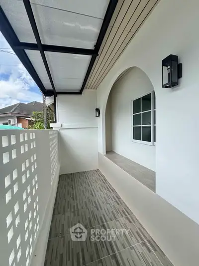 Charming balcony with modern design and stylish lighting, perfect for relaxation.