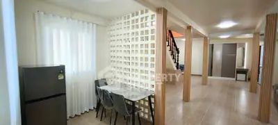 Spacious open-plan living area with modern design and natural light
