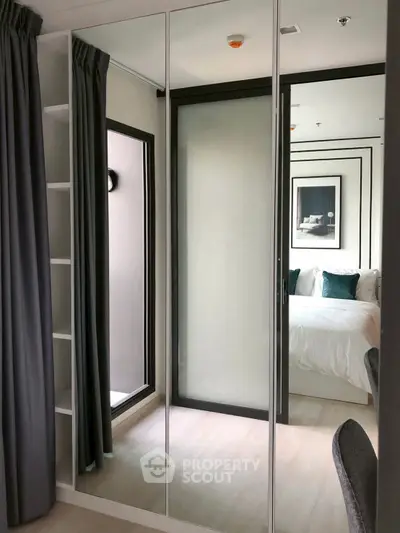Modern bedroom with mirrored closet doors and elegant decor