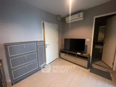 Modern living room with sleek furniture and air conditioning, ideal for comfortable living.