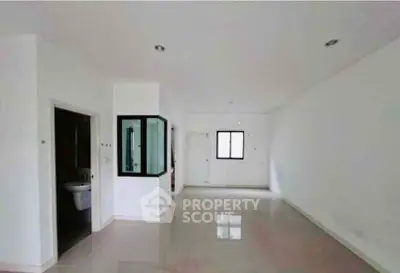 Spacious open-plan living area with sleek modern design and ample natural light.