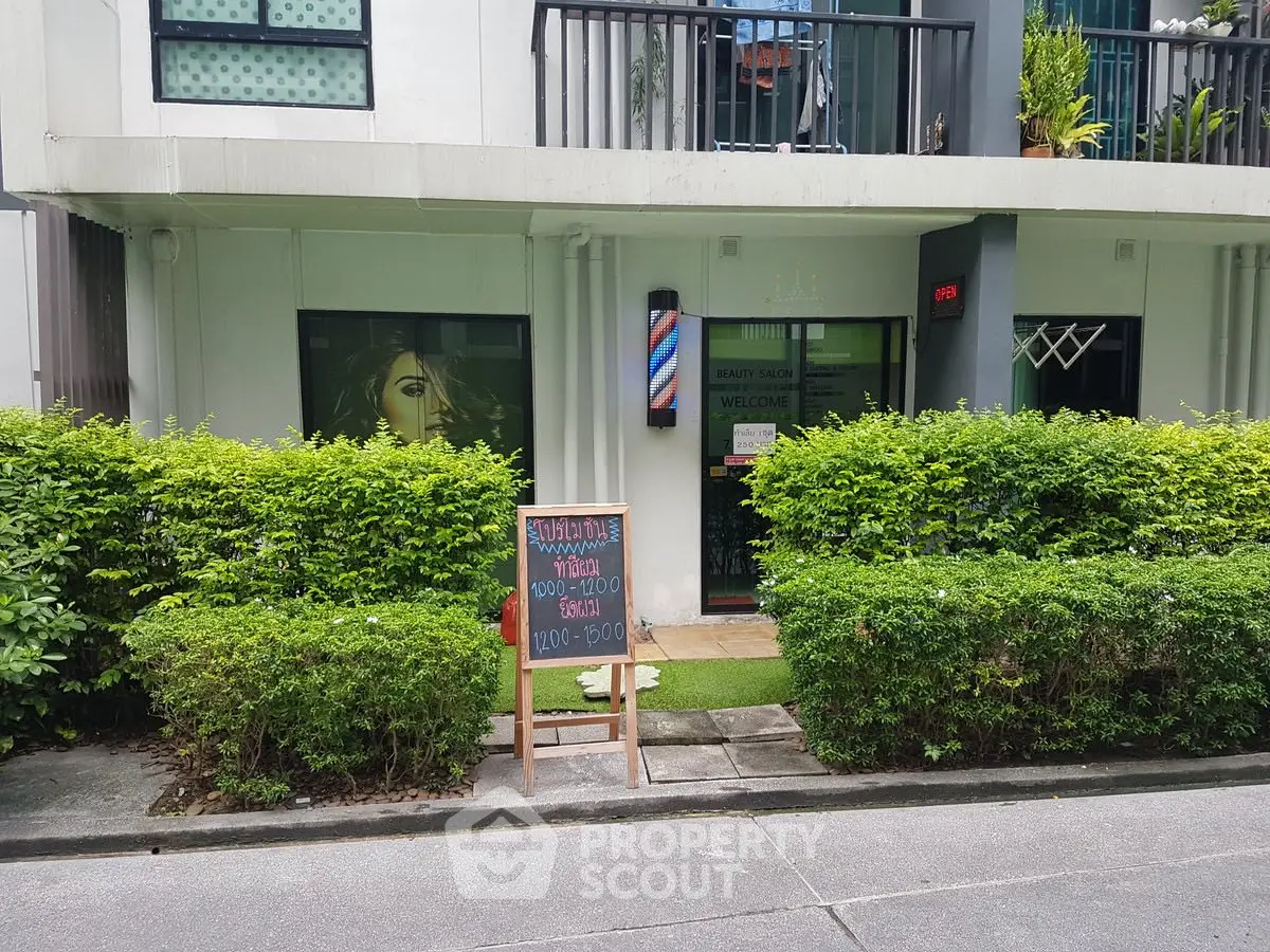 Charming beauty shop exterior with lush greenery and welcoming entrance